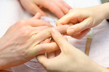 Image of male hands receiving a manicure